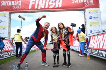 Adam Hills and Sienna (9) and mum Jo at the Superhero TRI, powered by Marvel 2023