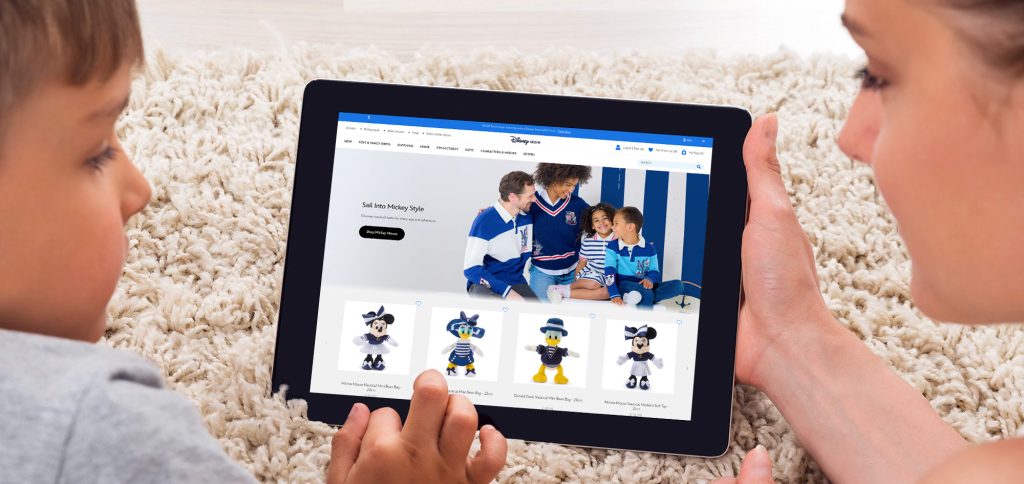 Woman and child looking at Disney site on tablet device