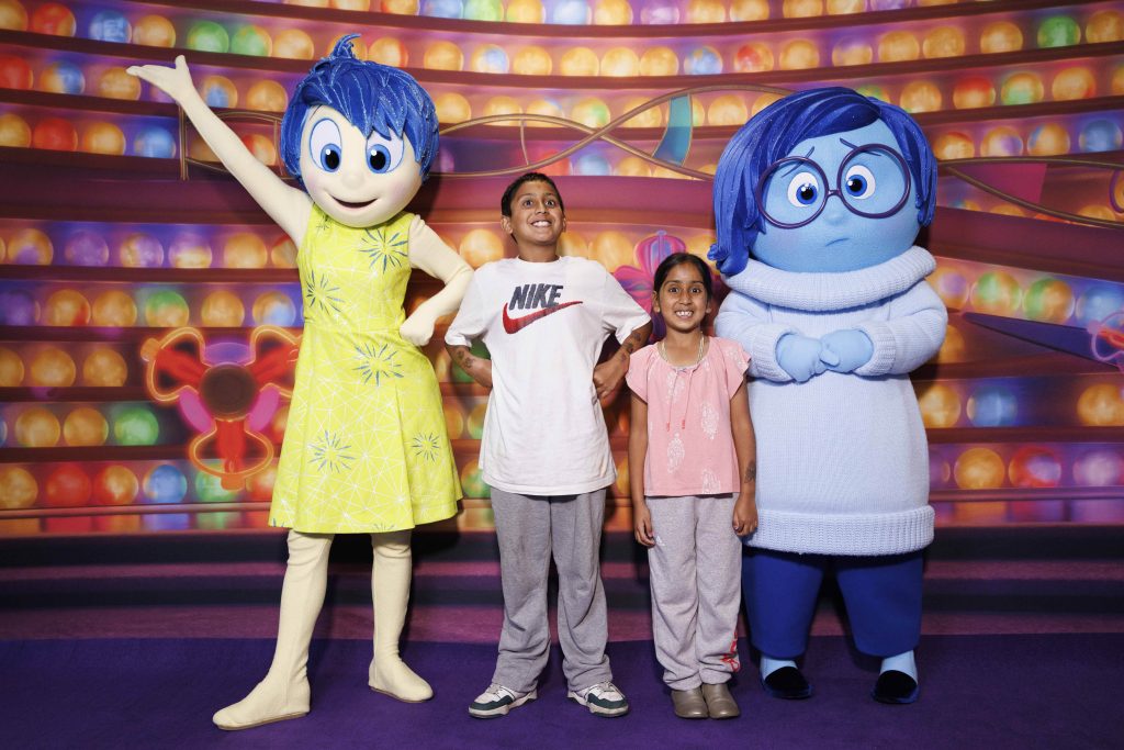 2 children with characters from Inside Out 2