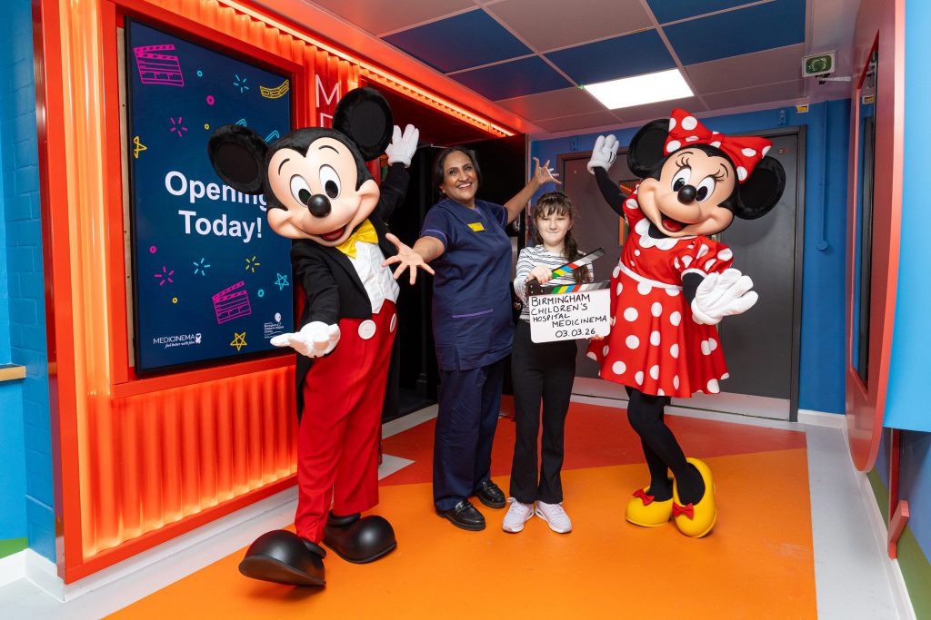 Mickey & Minnie with a nurse and a child at the Birmingham MediCinema launch