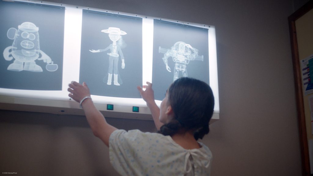 Child looking at x-rays of 3 cahracters from Toy Story 5