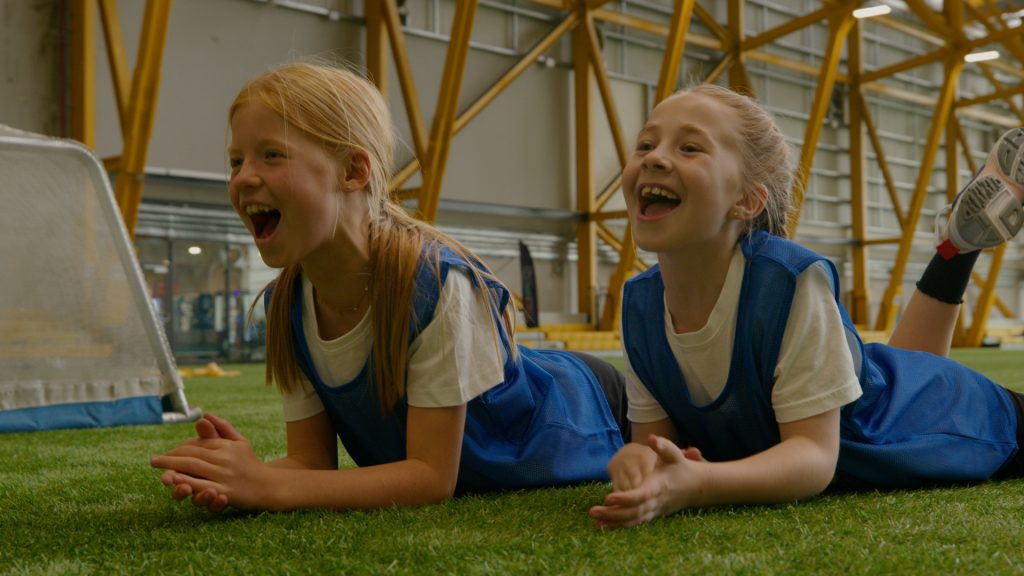 Girls lying on ground during Play games activity